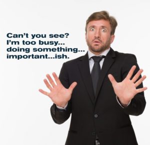 Picture of frightened businessman isolated on white background. Man in business suit showing fear with his hands.